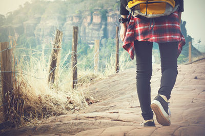 Low section of woman standing on land