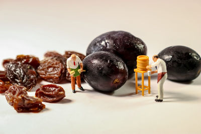 Close-up of fruits on table against white background