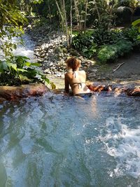 Man relaxing in swimming pool