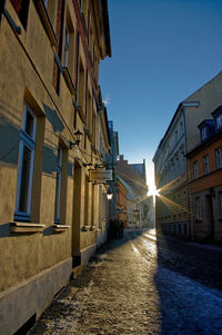 Street amidst buildings against clear sky