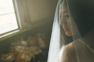 Close-up of bride wearing wedding dress