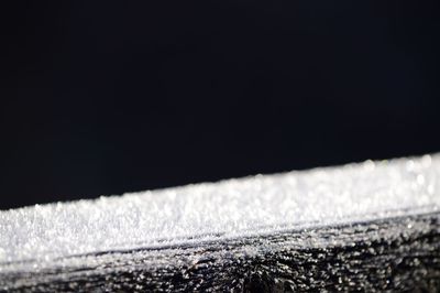Close-up of water drops on sea against clear sky