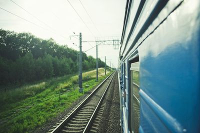 Railroad tracks amidst trees against sky