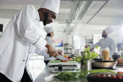 Chefs preparing food in commercial kitchen