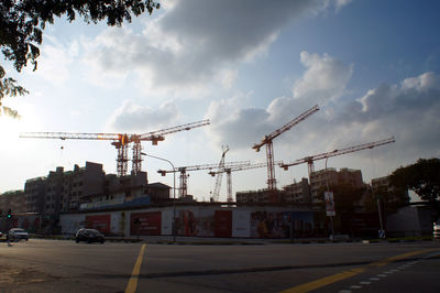 Construction site in city against sky