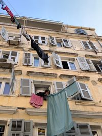 Low angle view of clothes drying outside building