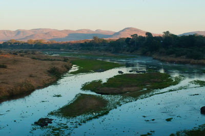 Scenic view of lake and mountains against sky