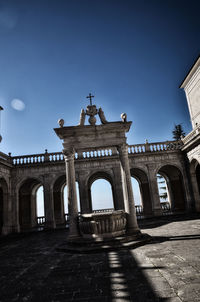 Low angle view of historical building against blue sky