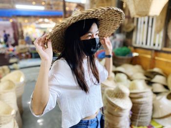 Smiling woman wearing hat standing at home