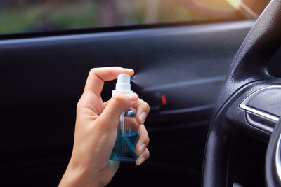 Close-up of person hand holding car