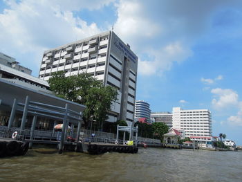 Swimming pool in city against sky