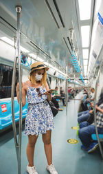 Low angle view of woman standing on train