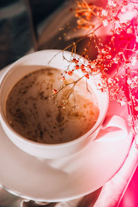 White cup of milk and chocolate. morning aesthetics vibes. breakfast. pink gypsophila flowers. hard 