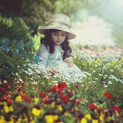 Full length of woman with flowers on field