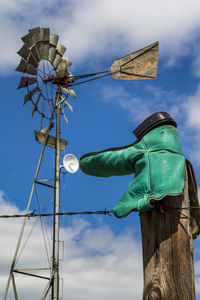 Low angle view of windmill against sky