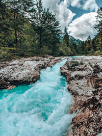 Scenic view of waterfall against sky