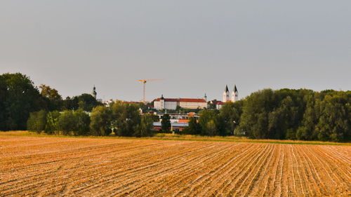 Scenic view of agricultural field with cathedral in the  backround