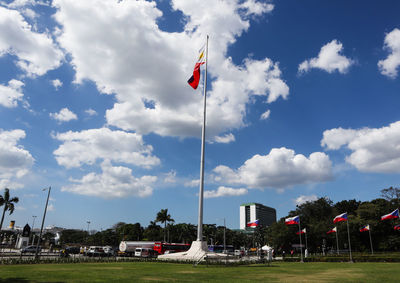 Red flag by street against sky