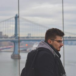 Portrait of young man looking at city