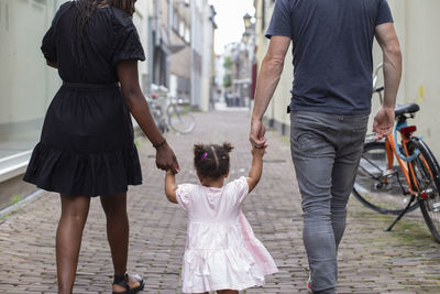 An interracial family walking in a dutch city