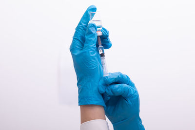 Close-up of person photographing against white background