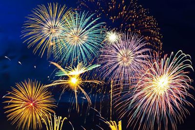 Low angle view of firework display at night