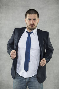 Portrait of young man standing at home