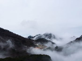 Scenic view of mountains against cloudy sky