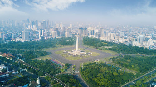 Aerial view of buildings in city against sky