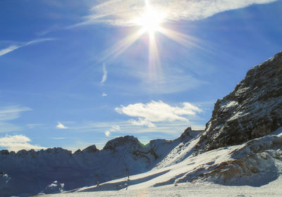 Scenic view of snow covered mountains against sky