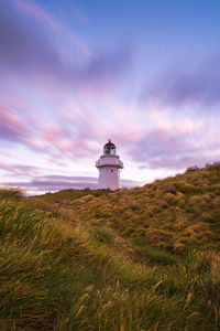 Lighthouse against sky during sunset