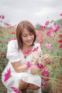 Portrait of young woman holding flower