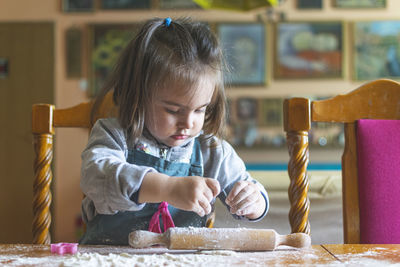 Cute girl making cookie at home
