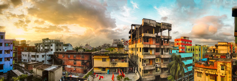 Buildings against cloudy sky