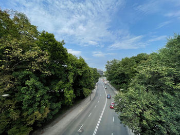 Road amidst trees against sky