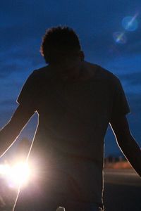 Low angle view of silhouette man standing against sky