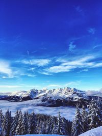 Scenic view of snowcapped mountains against blue sky