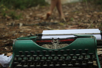 High angle view of vintage typewritter on field