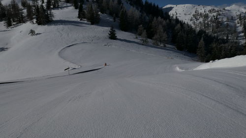 View of people skiing on snow covered mountain