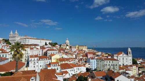 View of cityscape against blue sky