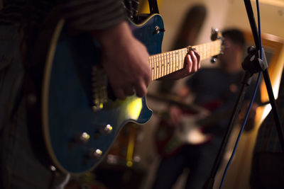 Close-up of man playing guitar