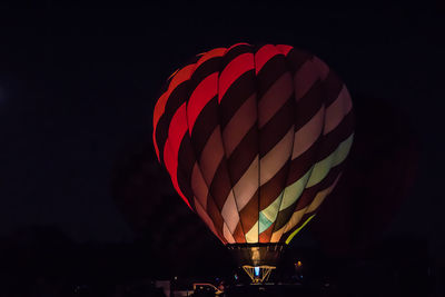 Low angle view of hot air balloon against sky at night