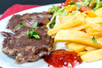 Close-up of beef steak and french fries in plate