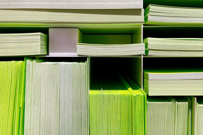 Stacks of green paper in shelf