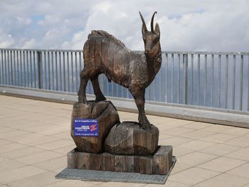 Statue of horse against cloudy sky