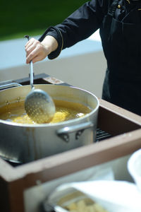 Midsection of man preparing food