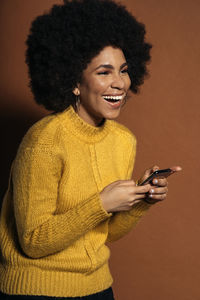 Portrait of smiling young man using mobile phone