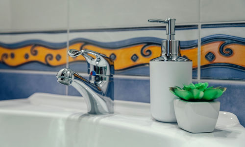 Close-up of faucet in bathroom at home