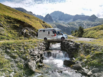 Scenic view of river amidst mountains against sky