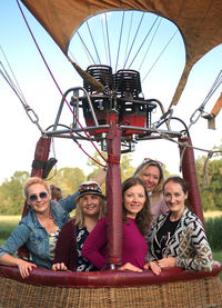 Portrait of friends standing in hot air balloon